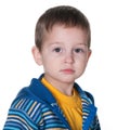 Serious kid in a striped blue and yellow jacket