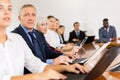 Mature white businessman sitting at meeting and listening to presentation Royalty Free Stock Photo