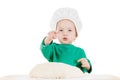 Serious little boy kneading dough for the cookies, isolated on white Royalty Free Stock Photo