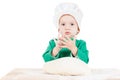 Serious little boy kneading dough for the cookies, isolated on white Royalty Free Stock Photo