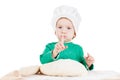 Serious little boy kneading dough for the cookies, isolated on white Royalty Free Stock Photo