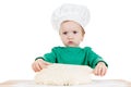 Serious little boy kneading dough for the cookies, isolated on white Royalty Free Stock Photo