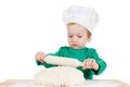 Serious little boy kneading dough for the cookies, isolated on white Royalty Free Stock Photo