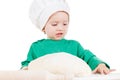 Serious little boy kneading dough for the cookies, isolated on white Royalty Free Stock Photo