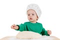 Serious little boy kneading dough for the cookies, isolated on white Royalty Free Stock Photo