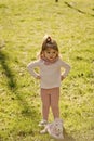 Serious little girl. Child girl play with horse toy on green grass Royalty Free Stock Photo