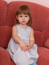 Serious little girl on the sofa Royalty Free Stock Photo