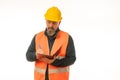 Serious-looking caucasian construction manager making notes on white background