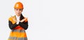 Serious-looking fed up asian female boss, construction manager in safety helmet showing cross gesture to stop, prohibit