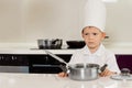 Serious looking little chef in the kitchen