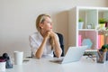 Serious looking woman thinking about something at workplace Royalty Free Stock Photo