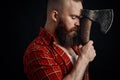 Lumberjack. Confident bearded man attached to forehead axe
