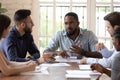 Serious male black executive talk to staff people at briefing Royalty Free Stock Photo