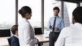 Serious male boss and diverse employees talking, discussing work issues Royalty Free Stock Photo