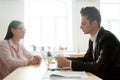 Serious male boss reading resume considering applicant candidatu Royalty Free Stock Photo