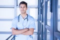 Serious male doctor standing with arms crossed Royalty Free Stock Photo