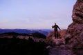 Serious male traveler (man) standing by a huge rock in Carpathian mountains Royalty Free Stock Photo