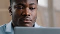 Serious male young african american businessman programmer typing on computer at home office focused concentrated Royalty Free Stock Photo