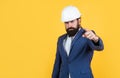 serious man with beard wear hard hat pointing finger. engineering. architecture and building. male builder wearing