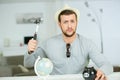 Serious man breaking piggy bank with hammer Royalty Free Stock Photo