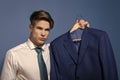 Serious man. Businessman in white shirt, necktie hold jacket on hanger Royalty Free Stock Photo