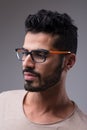 Serious man, colorful glasses, side portrait