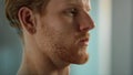 Serious man face expression closeup. Tired ginger worker resting after hard day Royalty Free Stock Photo