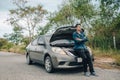 Serious man fold oneÃ¢â¬â¢s arms over the chest front of car breakdown and open bonnet on roadside. Car broken concept Royalty Free Stock Photo