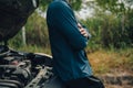 Serious man fold oneÃ¢â¬â¢s arms over the chest front of car breakdown and open bonnet on roadside. Car broken concept Royalty Free Stock Photo