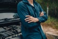 Serious man fold oneÃ¢â¬â¢s arms over the chest front of car breakdown and open bonnet on roadside. Car broken concept Royalty Free Stock Photo