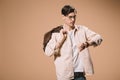 Serious man in glasses looking at watch while standing with bag isolated Royalty Free Stock Photo