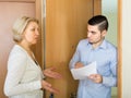 Serious man and housewife at the door Royalty Free Stock Photo