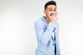 Serious man in a jacket joked and laughs on a white studio background