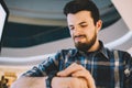 Serious man looking at his watch while standing on the urban background Royalty Free Stock Photo