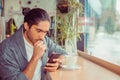 Serious man looking at phone, worried by news he received Royalty Free Stock Photo