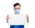 Serious man in protective respiratory mask holds a blank white banner, isolated on white background. Attention, stop virus concept