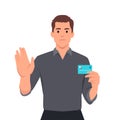 Serious man shows stop gesture and holding credit card. Man say no or reject credit card