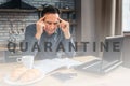 Serious man sit at table in kitchen and reading. He look down at journal and hold hands on head. Man look concentrated.