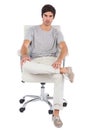 Serious man sitting on a swivel chair