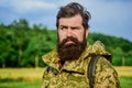Serious man. soldier in military uniform. brutal male poacher. male beard care. bearded man hiking with backpack. mature