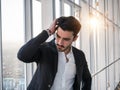 Serious man standing inside modern building Royalty Free Stock Photo