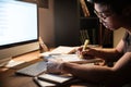 Serious man studying with books and computer in dark room Royalty Free Stock Photo