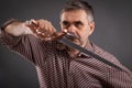 Serious man with sword in his hands. The concept of constant stress in everyday life Royalty Free Stock Photo