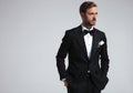 Serious man wearing tuxedo and standing with hands in pockets Royalty Free Stock Photo