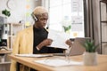 Serious marketing african man in suit and headset talking to client on video call Royalty Free Stock Photo