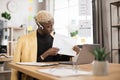 Serious marketing african man in suit and headset talking to client on video call Royalty Free Stock Photo