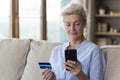 Serious mature bank client woman making online payment Royalty Free Stock Photo