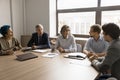 Serious mature business leader woman talking to diverse colleagues Royalty Free Stock Photo