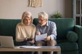 Serious mature couple calculating bills, checking domestic finances Royalty Free Stock Photo