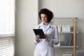 Serious mature female doctor using tablet computer Royalty Free Stock Photo